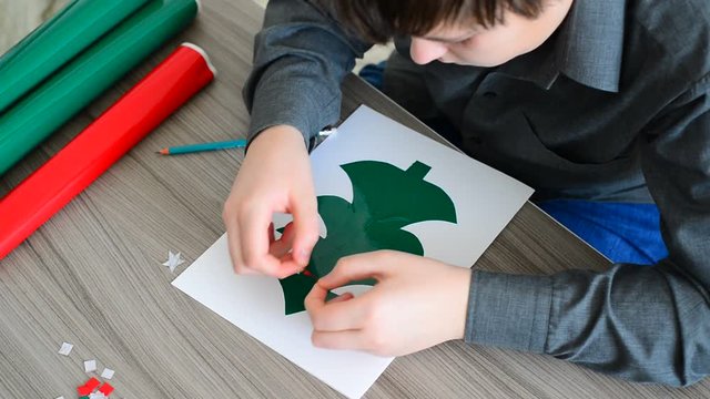Teen Boy making Christmas card