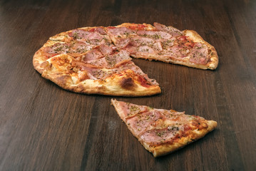 Slice of pizza on wooden table