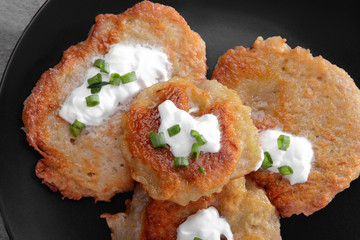 Plate with tasty potato pancakes for Hanukkah, closeup