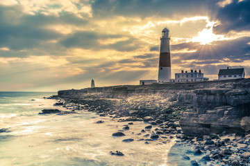 Dramatic sunset with iconic lighthouse on coast