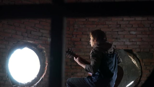 young boy playing a guitar