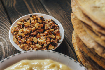 Close up of nuts in a plate among ingredients for homemade cake. 