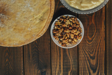 Ingredients for baking a cake, top view on wooden board. shortcakes, buttercream