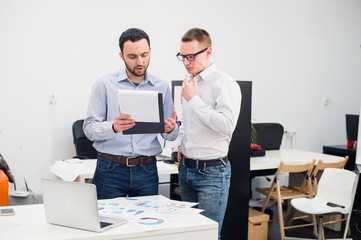 two caucasian corporate executives in casual wear having a business discussion in office.