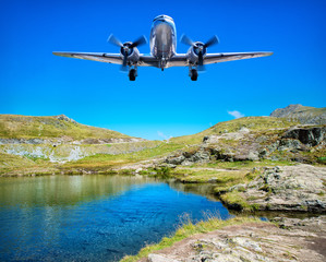Fototapeta na wymiar airplane flying over a lake in the mountains