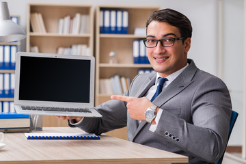 Young handsome businessman working on office