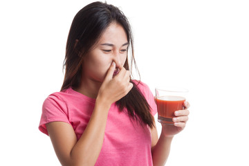 Young Asian woman hate tomato juice.