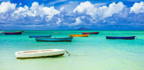 old rustic fishermen' boats in turquoise sea. Mauritius island scenery