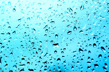Rainy wet cold blue abstract eco seasonal natural blurred background with water drops