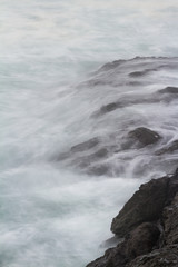 silky waves crashing on the rocks