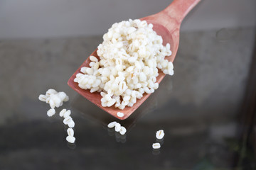 Grains in a wooden ladle