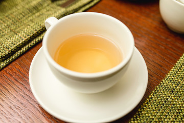 Yellow soft herbal tea in a cup in the restaurant