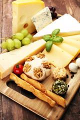 Cheese platter with different cheese and grapes