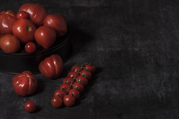  tomatoes on black background
