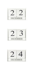 Closeup group of white wooden calendar with black 22 , 23 , 24 december  word , three date calendar isolated on white background