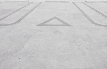 Closeup surface old and pale yellow painted sign for parking slot line on cement street floor in the car park textured background in black and white tone with copy space