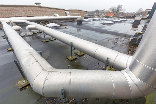 Ventilation pipes on flat roof of school building
