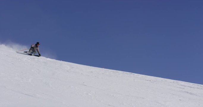 Spectacular Wide Slow Motion Of Skier Carving Down The Slope With Snow Spraying 