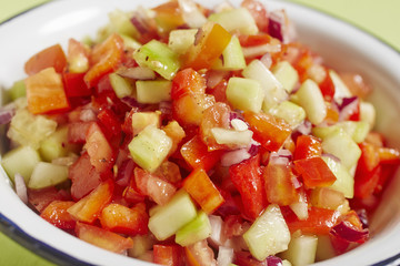 A bowl of Israeli tomato and cucumber salad 