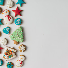 Colorful pattern made of Christmas cookies and red berries. Flat