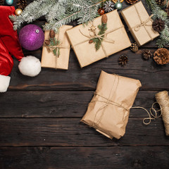 Christmas composition with decorations and gifts on wooden board