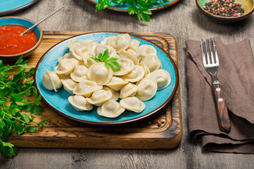 A dish with ravioli on the wooden board