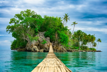Bamboo hanging bridge over sea to tropical island - obrazy, fototapety, plakaty