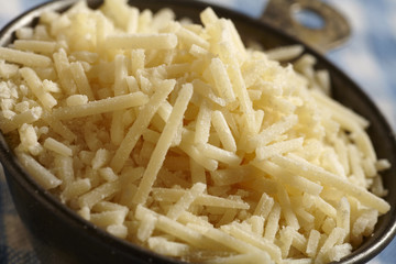 A cup of shredded Parmesan cheese