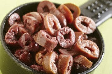 A cup of sliced black olives