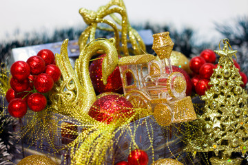 box with Christmas decorations in gold and red