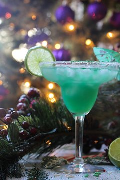Green cocktail against xmas holiday background, selective focus