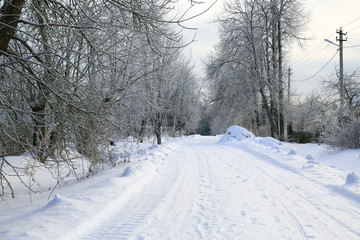 Snow-covered country road. Footprints in the snow