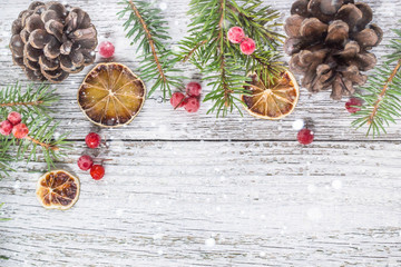 Christmas branches with cones viburnum berries and dry lemon slice
