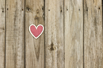 Country heart hanging on antique rustic wood background