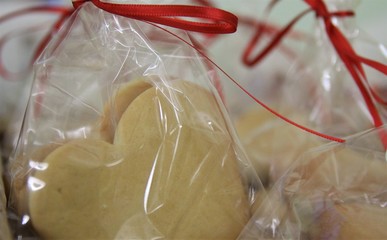 Cookie in plastic bag packet. Gift. Holiday gift boxes decorated with ribbon