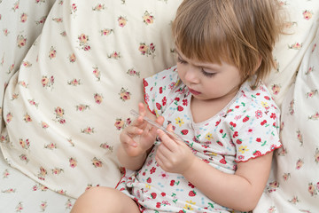 Child is studying temperature on thermometer