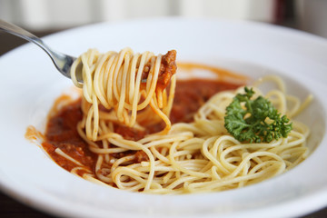 spaghetti bolognese in wood background