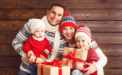 happy family mother, father and children with Christmas gifts on