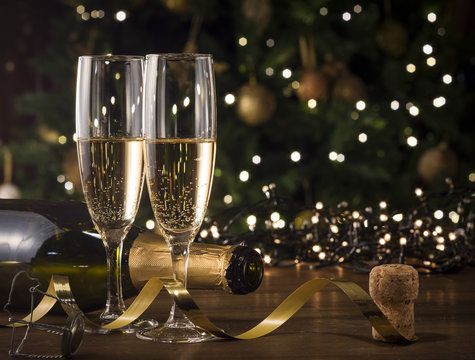 New Year Toast champagne , Christmas tree background