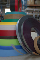 Furniture accessories. Multicolored bobbins of PVC edge and melanin for the manufacture of furniture. Lie pyramid.