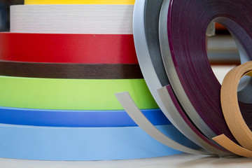 Furniture accessories. Multicolored bobbins of PVC edge and melanin for the manufacture of...