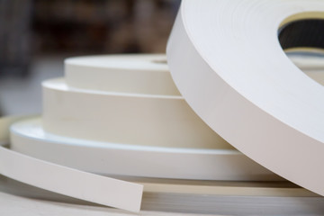 Furniture accessories. Multicolored bobbins of PVC edge and melanin for the manufacture of furniture. Lie pyramid.