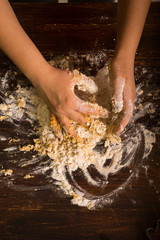 Preparing pastry for gingerbread. Kneading ingredients by hands. 