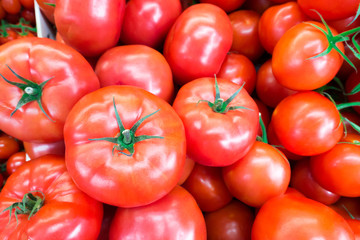 Close up of fresh, juicy, ripe tomatoes pile. lycopene and antioxidant in fruit nutrition good for health and skin. flat lay