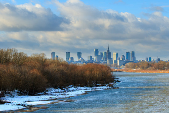 Fototapeta Warsaw sky line with skyscrapers of city center, Vistula river shore in winter