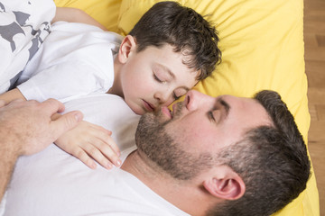 Fototapeta na wymiar Father and son in bed, happy time