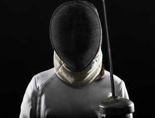 Portrait of woman wearing white fencing costume practicing with the sword.