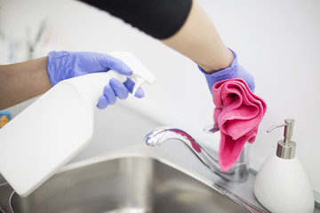 Cleaning lady cleans cleaning tap