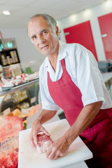 Fototapeta na wymiar butcher posing with a piece of meat