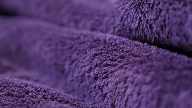 Highly decorative purple polar fleece close-up 4K 2160p 30fps UltraHD panning footage - Slow pan on synthetic fibers of warm violet blanket 3840X2160 UHD video 